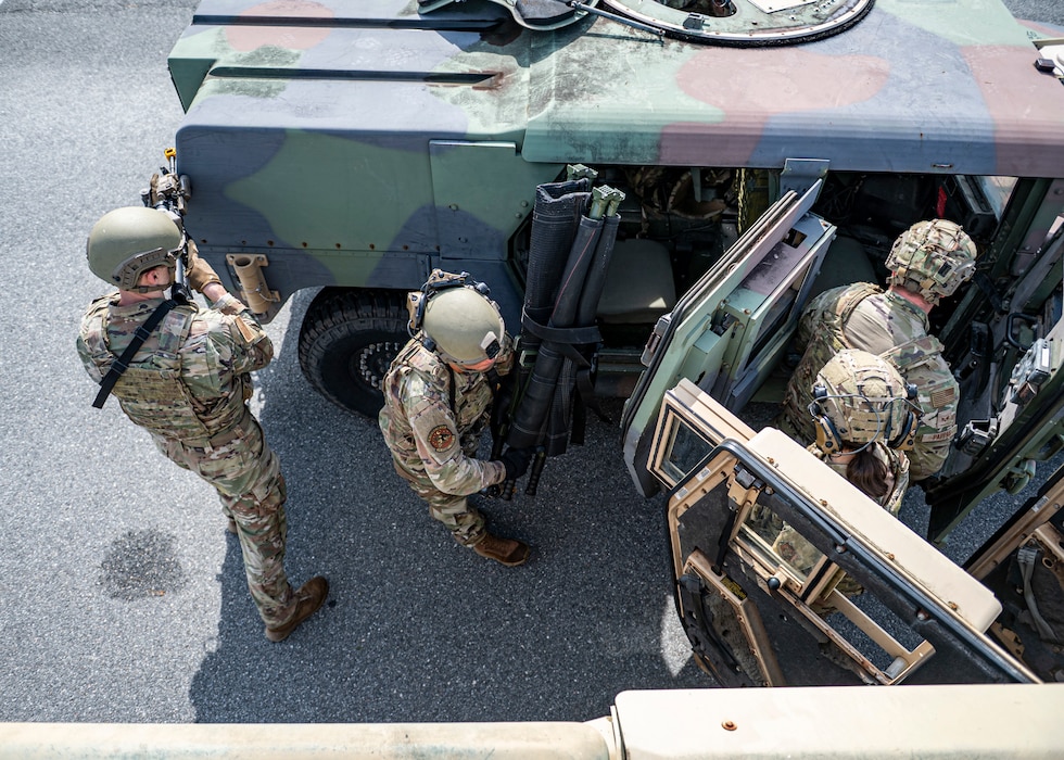Airmen with the 910th Security Forces Squadron, Youngstown Air Reserve Station, Ohio, perform transfer drills at Moody Air Force Base, Georgia, June 20, 2025. In case of one of the vehicles become inoperable, Airmen must quickly move their gear and themselves to the other convoy vehicle, while securing the perimeter. (U.S. Air Force photo by Senior Airman Leonid Soubbotine)