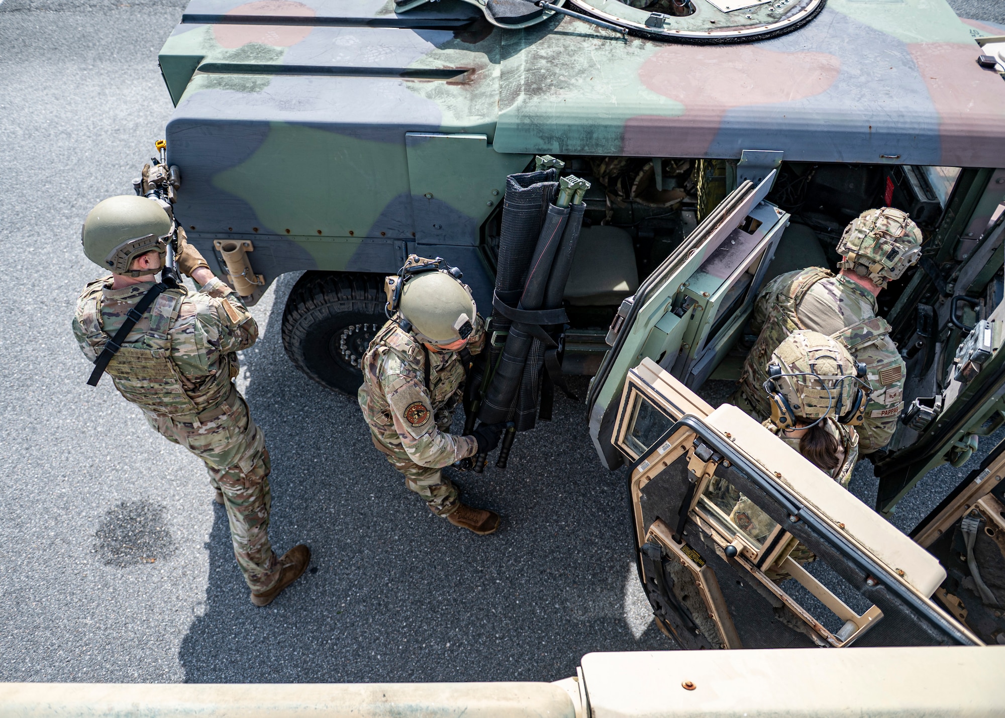 Airmen with the 910th Security Forces Squadron, Youngstown Air Reserve Station, Ohio, perform transfer drills at Moody Air Force Base, Georgia, June 20, 2025. In case of one of the vehicles become inoperable, Airmen must quickly move their gear and themselves to the other convoy vehicle, while securing the perimeter. (U.S. Air Force photo by Senior Airman Leonid Soubbotine)