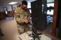 U.S. Army 1st Sgt. Sahib Singh and Spc. Islam Mahmoud, financial management technicians with the 1946th Finance Company, examine a weapons system on Fort Indiantown Gap, Pa., June 11, 2025. The 1946th did extensive firearm and maintenance and marksmanship training as part of their annual training. (U.S. Army Photo by Spc. Carrol Hughes)