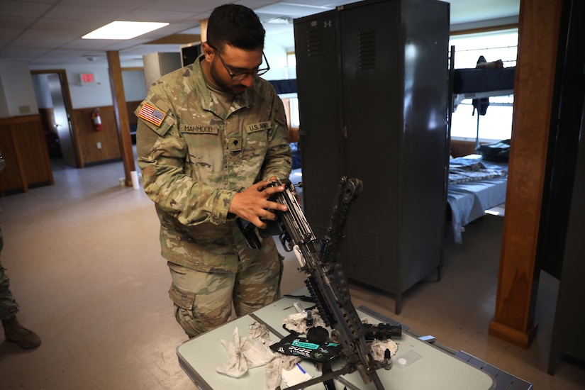 U.S. Army 1st Sgt. Sahib Singh and Spc. Islam Mahmoud, financial management technicians with the 1946th Finance Company, examine a weapons system on Fort Indiantown Gap, Pa., June 11, 2025. The 1946th did extensive firearm and maintenance and marksmanship training as part of their annual training. (U.S. Army Photo by Spc. Carrol Hughes)