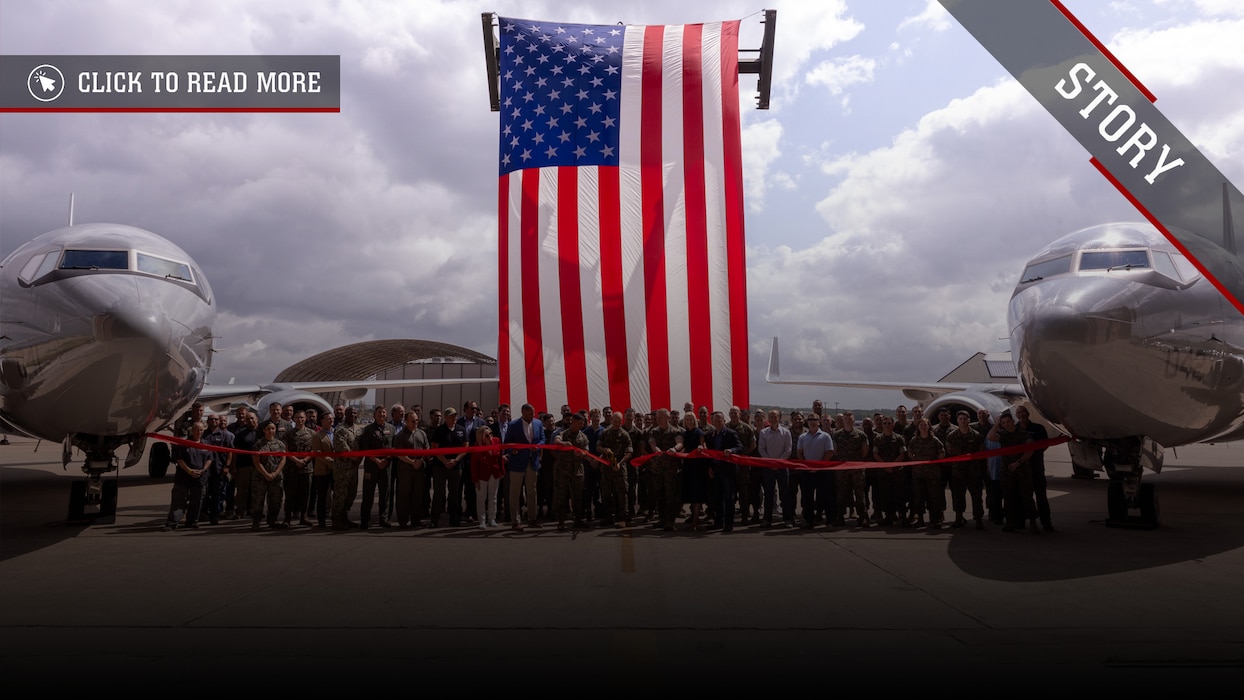 U.S. Marines with Marine Transport Squadron (VMR) 1 and civilians cut a ribbon after a ceremony recognizing the unit’s classification as a full operational capability squadron at Naval Air Station Joint Reserve Base Fort Worth, Texas, June 18, 2025. VMR-1’s achievement of full operational capability with the C-40A aircraft, marks a significant milestone in squadron readiness and success. (U.S. Marine Corps photo by Cpl. Kanoa Thomas)