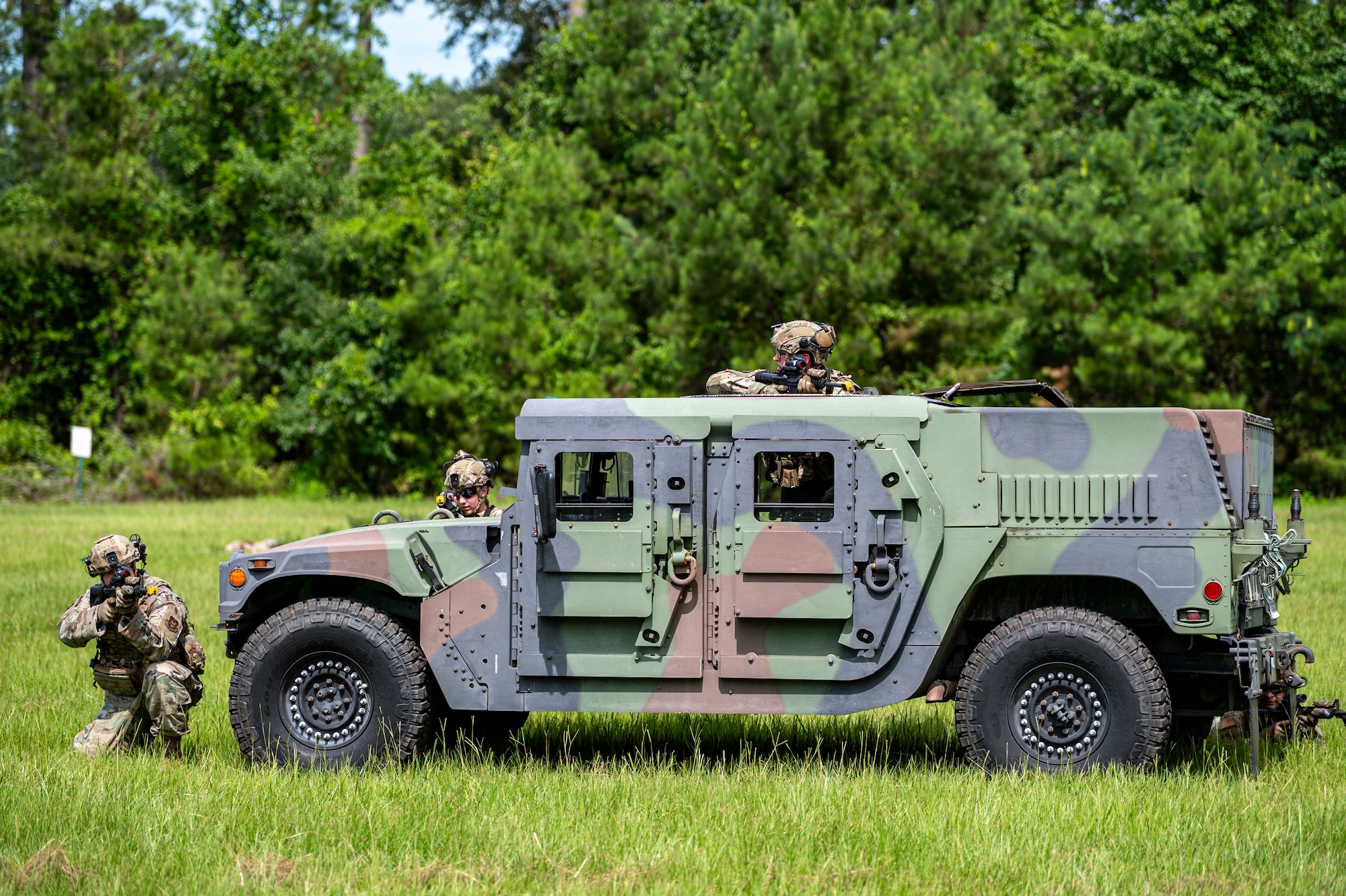 Airmen with the 910th Security Forces Squadron, Youngstown Air Reserve Station, Ohio, perform opposing force drills at Moody Air Force Base, Georgia, June 20, 2025. Using a vehicle for cover, Airmen engaged in simulated threats while maintaining 360-degree security, reinforcing battlefield communication and defensive positioning under fire. (U.S. Air Force photo by Senior Airman Leonid Soubbotine)