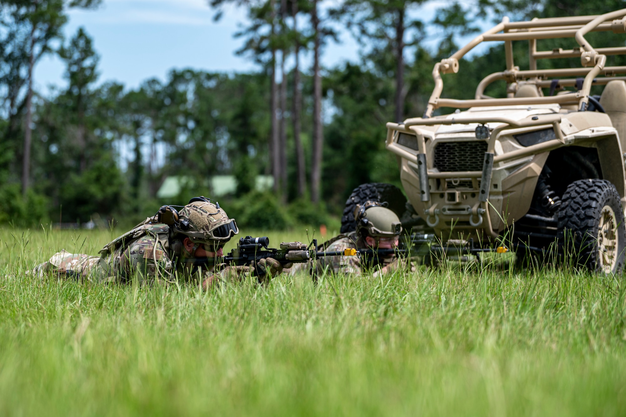 Airmen with the 910th Security Forces Squadron, Youngstown Air Reserve Station, Ohio, take aim from a prone position at Moody Air Force Base, Georgia, June 20, 2025. Airmen simulated overwatch and defensive tactics in a field environment while performing opposing force drills. (U.S. Air Force photo by Senior Airman Leonid Soubbotine)