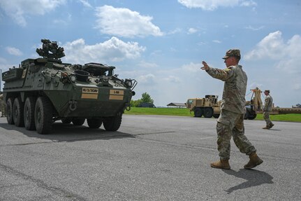 army soldiers parking Stryker combat vehicles