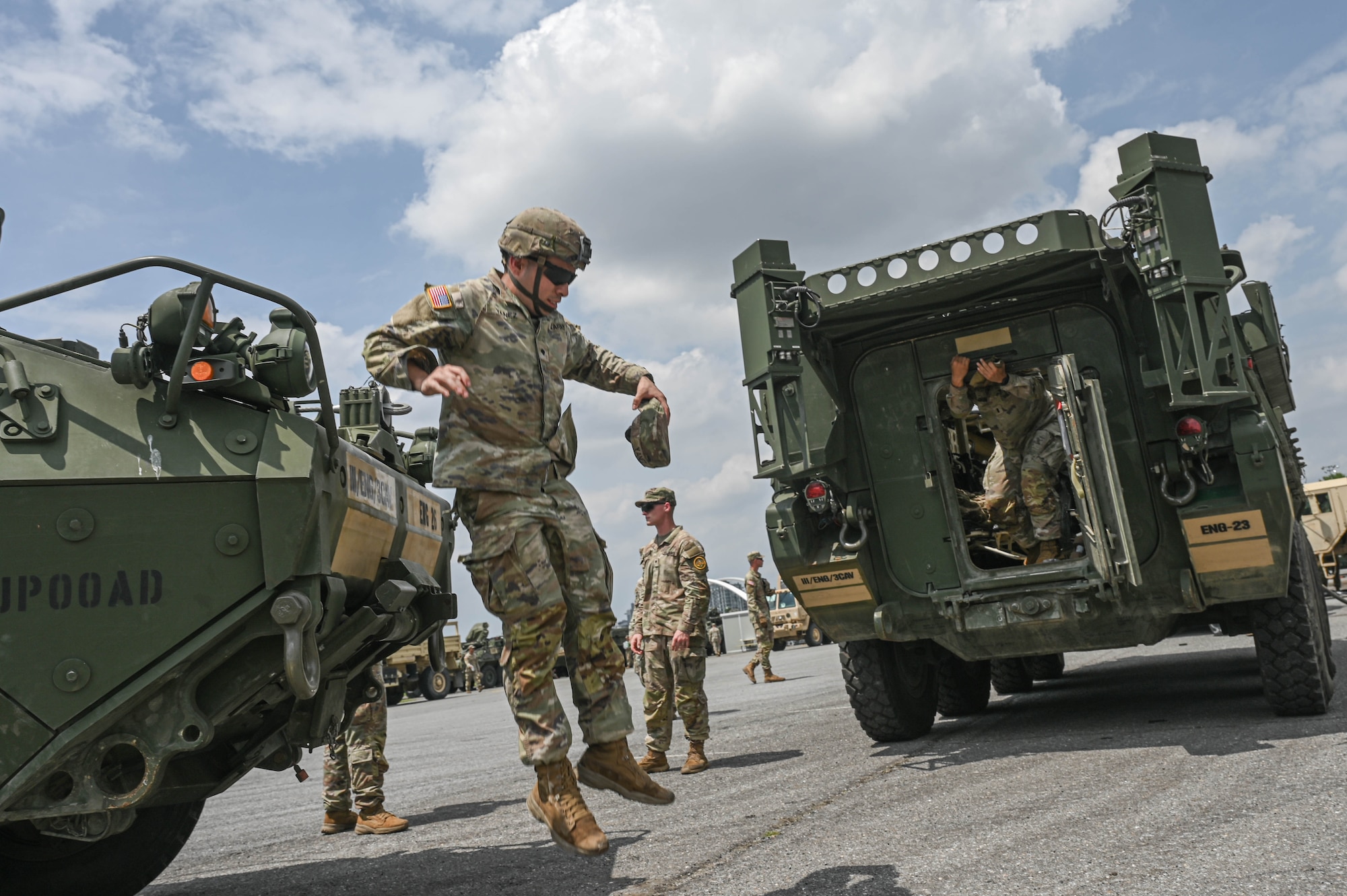 army soldiers parking Stryker combat vehicles