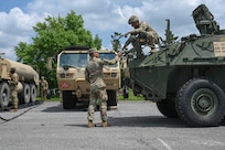 army soldiers parking Stryker combat vehicles