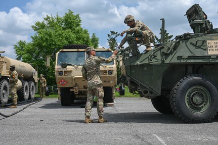 army soldiers parking Stryker combat vehicles