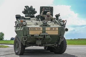 army soldiers parking Stryker combat vehicles