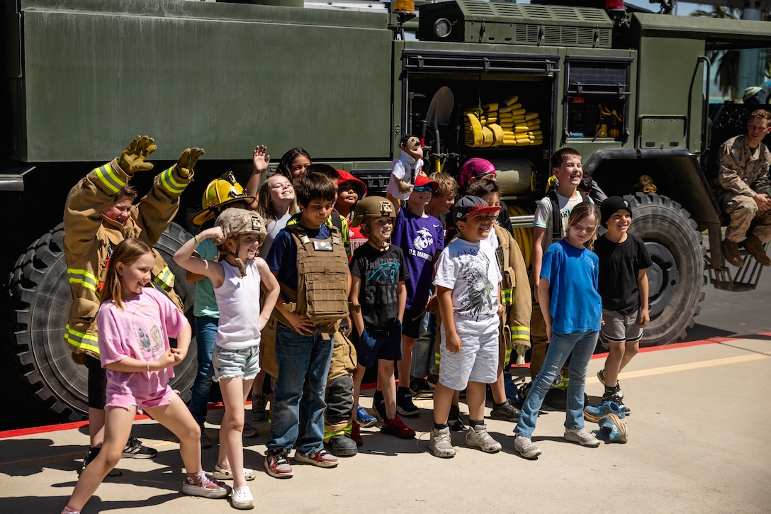 Students pose for a class photo during a military vehicle showcase hosted by The Combat Center at Twentynine Palms Elementary School, Twentynine Palms, California, April 24, 2025. The showcase was hosted in support of Month of the Military child, a month dedicated to recognizing the role that children have in supporting military members and the unique challenges they face growing up in a military family. (U.S. Marine Corps photo by Cpl. Iris Gantt)