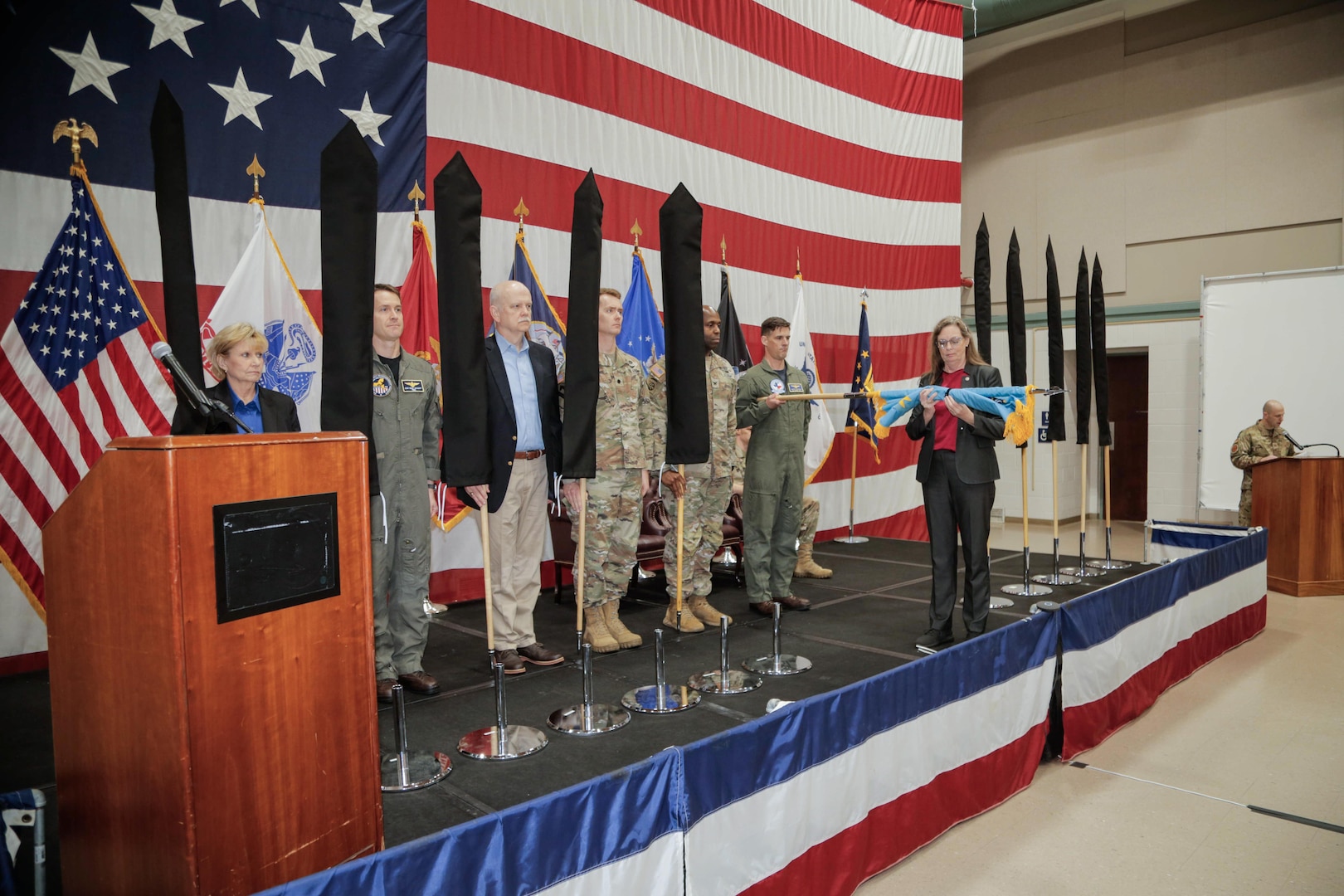 People stand at attention as a new flag is revealed