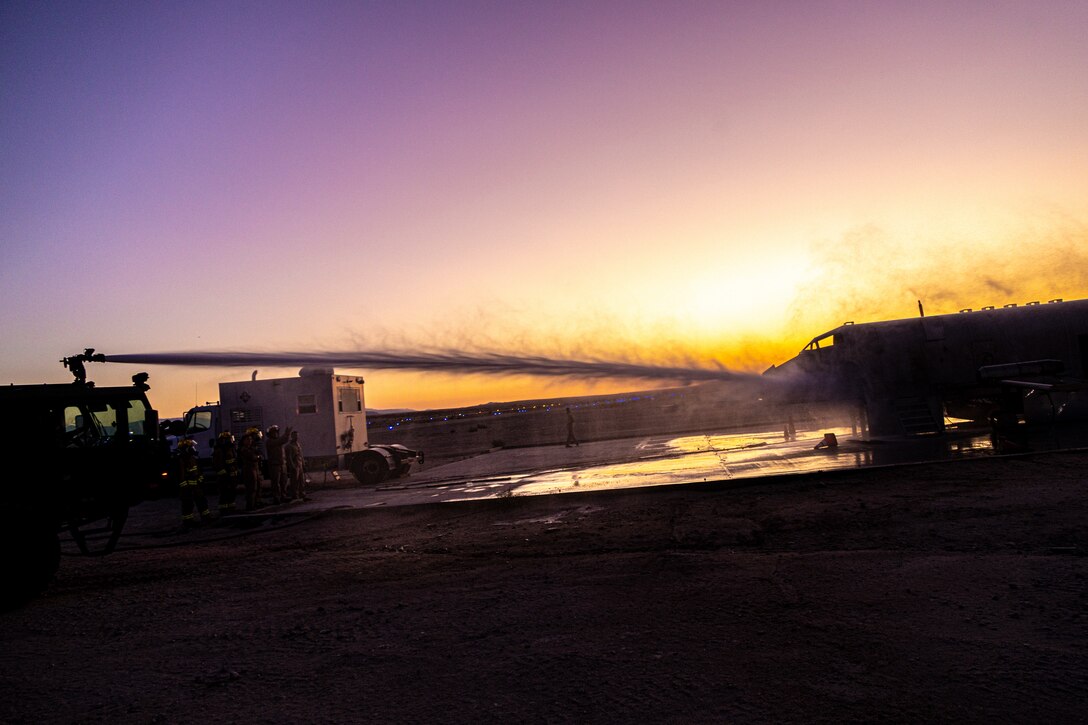 A U.S. Marine Corps P-19R Aircraft Rescue and Firefighting truck sprays water on a simulated fire during a simulated aircraft fire-fighting drill at Integrated Training Exercise 3-25, Marine Corps Air Ground Combat Center, Twentynine Palms, California, June 17, 2025. ITX is a critical Marine Air-Ground Task Force exercise for the Marine Forces Reserve’s training cycle, confirming unit readiness through live-fire and combined-arm integration. (U.S. Marine Corps photo by Lance Cpl. Edward Spears)
