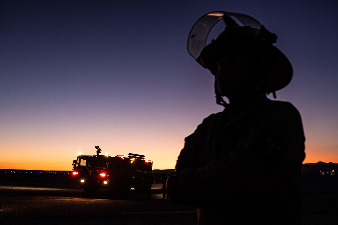 U.S. Marine Corps Staff Sgt. Oster Owens, a firefighter, with Aircraft Rescue and Fire Fighting, Marine Wing Support Squadron 472, 4th Marine Aircraft Wing pose for a photo during a simulated aircraft fire-fighting drill at Integrated Training Exercise 3-25, Marine Corps Air Ground Combat Center, Twentynine Palms, California, June 17, 2025. ITX is a critical Marine Air-Ground Task Force exercise for the Marine Forces Reserve’s training cycle, confirming unit readiness through live-fire and combined-arm integration. (U.S. Marine Corps photo by Lance Cpl. Edward Spears)
