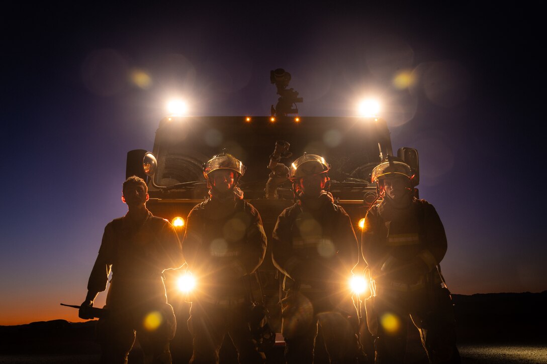 U.S. Marines with Aircraft Rescue and Fire Fighting, Marine Wing Support Squadron 472, 4th Marine Aircraft Wing, poses for a photo during a simulated aircraft fire-fighting drill at Integrated Training Exercise 3-25, Marine Corps Air Ground Combat Center, Twentynine Palms, California, June 17, 2025. ITX is a critical Marine Air-Ground Task Force exercise for the Marine Forces Reserve’s training cycle, confirming unit readiness through live-fire and combined-arm integration. (U.S. Marine Corps photo by Lance Cpl. Edward Spears)
