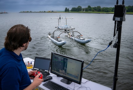 Raymond Koehler, a mechanical engineer at the Naval Air Warfare Center Aircraft Division, demonstrates unmanned swarm mission planning software at Naval Air Station Patuxent River’s West Basin Marina in Md. on June 17, 2025. The software helps the Navy plan missions with unmanned systems by simulating drone, sensor, and arrangement combinations to achieve mission goals at sea ultimately providing warfighters faster and more effective decision making. (U.S. Navy photo by Todd Frantom)