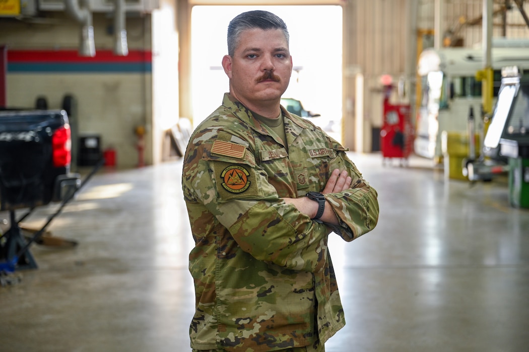 U.S. Air Force Master Sgt. Aaron Bell, 97th Logistics Readiness Squadron vehicle fleet manager, stands in the 97th Maintenance Squadron vehicle bay at Altus Air Force Base, Oklahoma, May 20, 2025. Bell was selected to compete for the top 9 Outstanding Airmen of the Year in Washington, D.C. (U.S. Air Force photo by Airman 1st Class Nathan Langston)