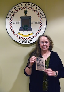Dr. Suni Edson, Assistant Technical Leader in Past Accounting, Armed Forces DNA Identification Laboratory for the Armed Forces Medical Examiner System, holds a photo of Blanchard Pruitt, her second cousin that was identified from the Cabanatuan POW camp at Dover Air Force base, Delaware, June 25, 2025. Blanchard Pruitt was born in 1923 in Jasper, Texas. He was a Private in the U.S. Army Medical Detachment of the 31st Infantry Regiment and was captured April 9, 1942, and was part of the Bataan Death March from the Bataan peninsula up to the CAB prison camp. He died on January 1, 1943, at the age of 20, and was believed to be buried in Common Grave 822 at the Cabanatuan Prison Camp.