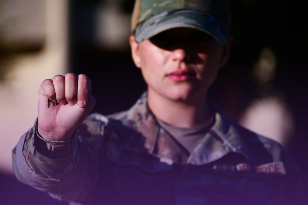 U.S. Air Force Airman 1st Class Lauren Torres displays the universal hand signal for domestic abuse at Altus Air Force Base, Oklahoma, Oct. 24, 2024.