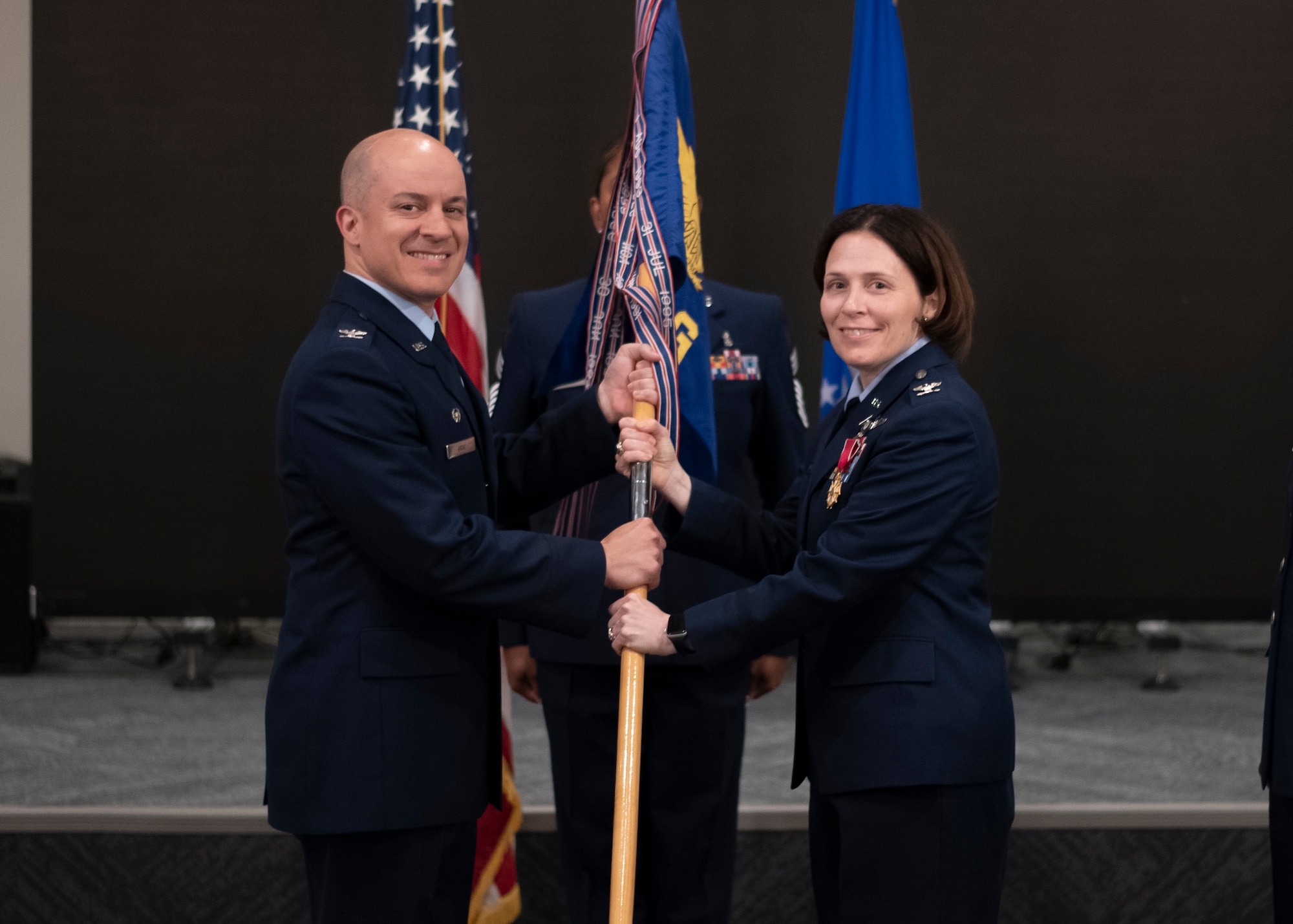 Man and woman holding flag
