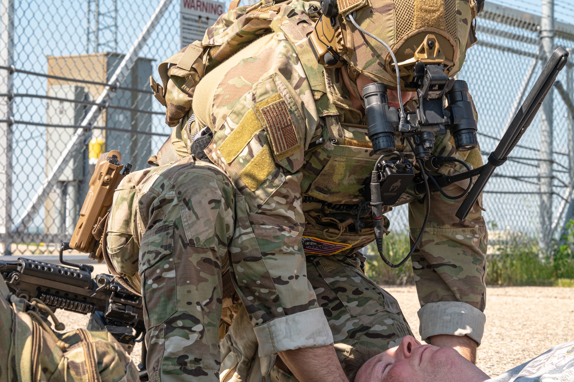 An Airman assigned to the 91st Security Forces Group tends to an injured civilian during a mass casualty exercise outside of Minot Air Force Base, North Dakota, June 17, 2025. Personnel during mass casualty exercises are able to work on rapid communication and response while identifying any strengths and weaknesses in trauma skills, communication, transportation, and casualty management.