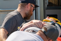 First responders load an injured man lying on a gurney during a mass casualty exercise outside of Minot Air Force Base, North Dakota, June 17, 2025. The exercise was in conjunction with the 91st Security Forces Group and 54th Helicopter Squadron as well as local first responders in an attempt to strengthen communication and response time.