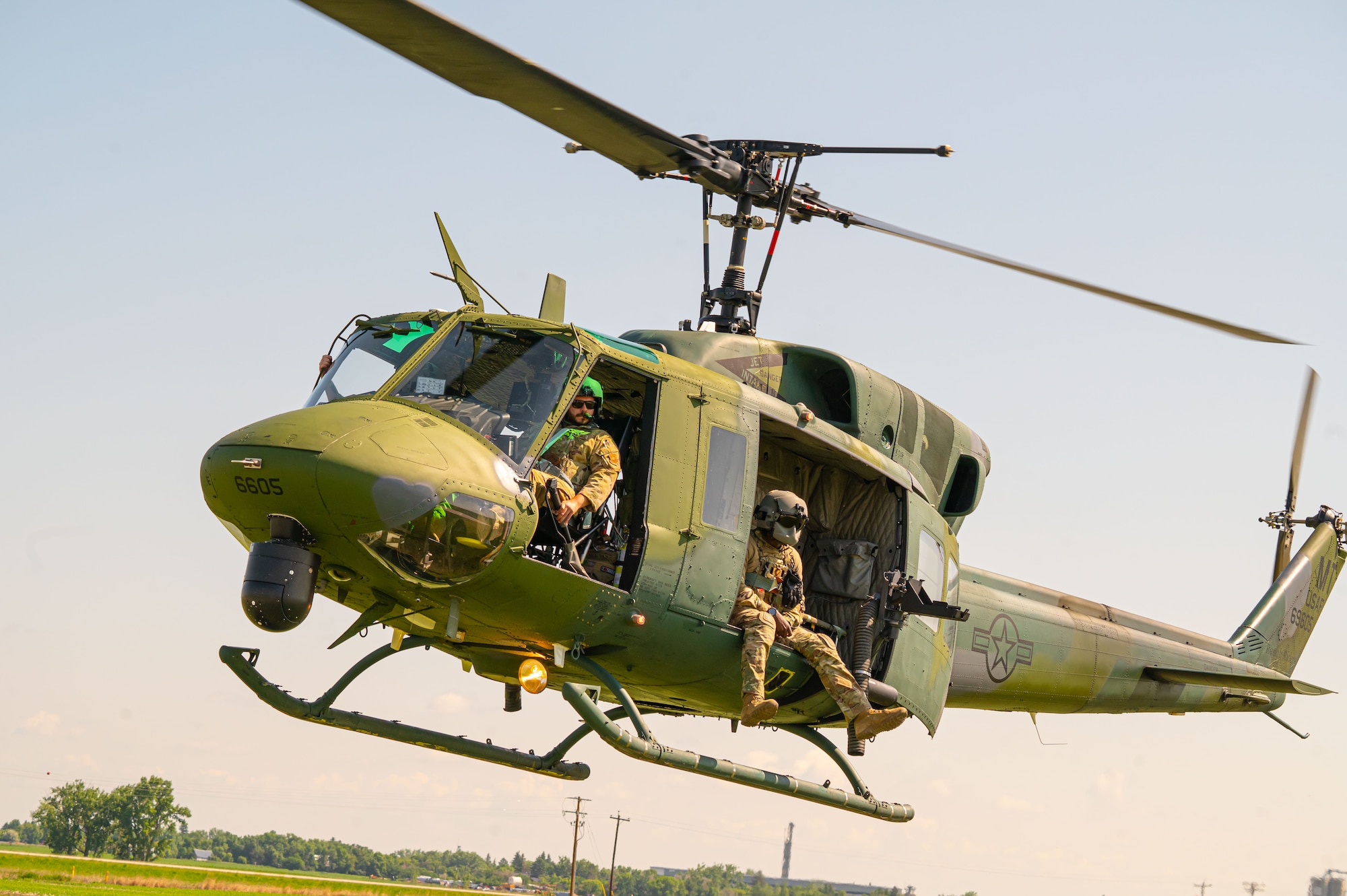 Pilots and Airmen assigned to the 54th Helicopter Squadron maneuver their UH-1N Iroquois helicopter into position outside of Minot Air Force Base, North Dakota, June 17, 2025. Traveling by helicopter can help insure a better survival rate in the case of a mass casualty event.
