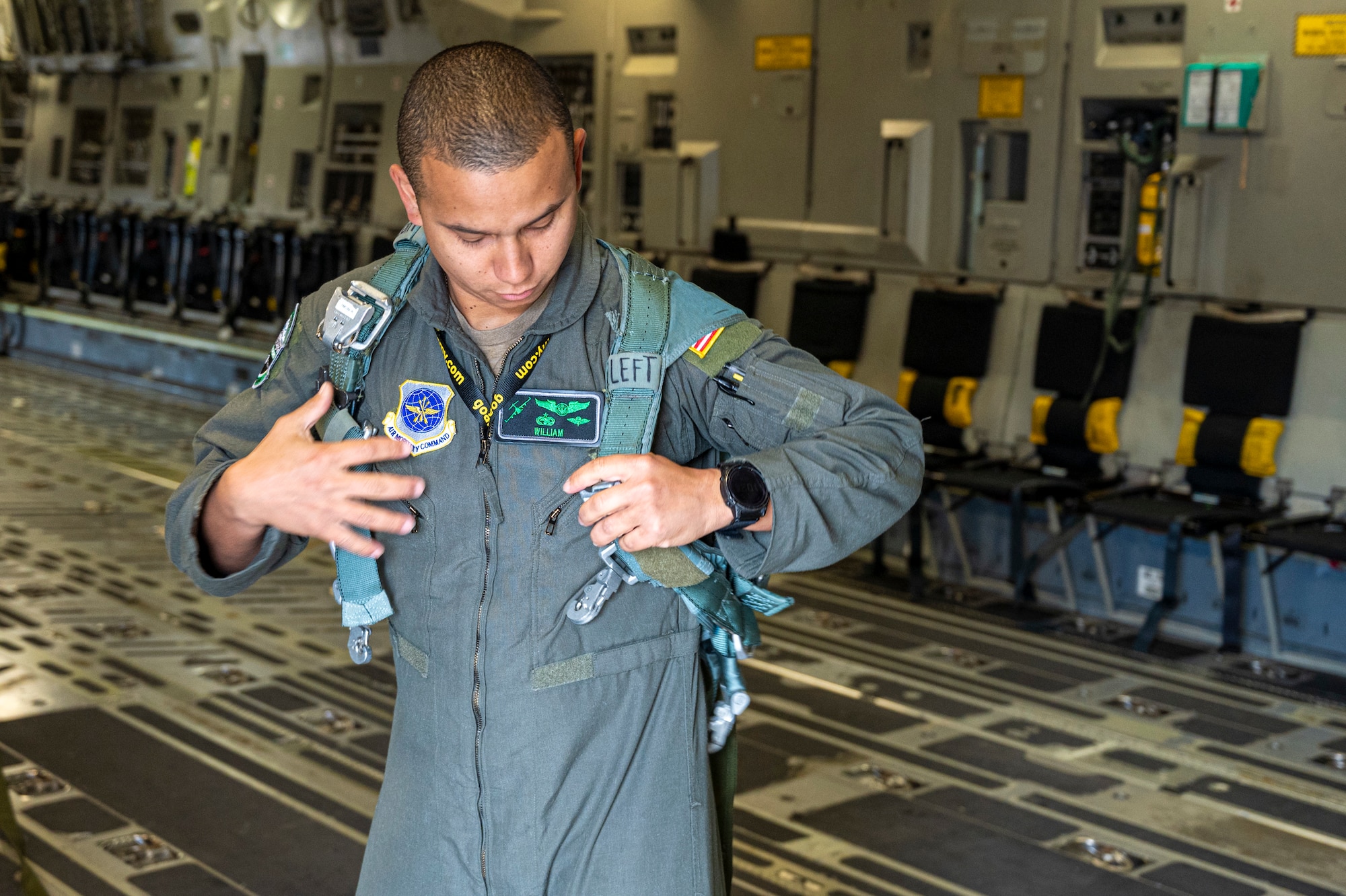 U.S Air Force Tech. Sgt. William Rodriguez-Febres, 8th Airlift Squadron instructor loadmaster, prepares a restraint harness during the 2025 Moses Lake Airshow at Grant County International Airport, Washington, June 19, 2025.