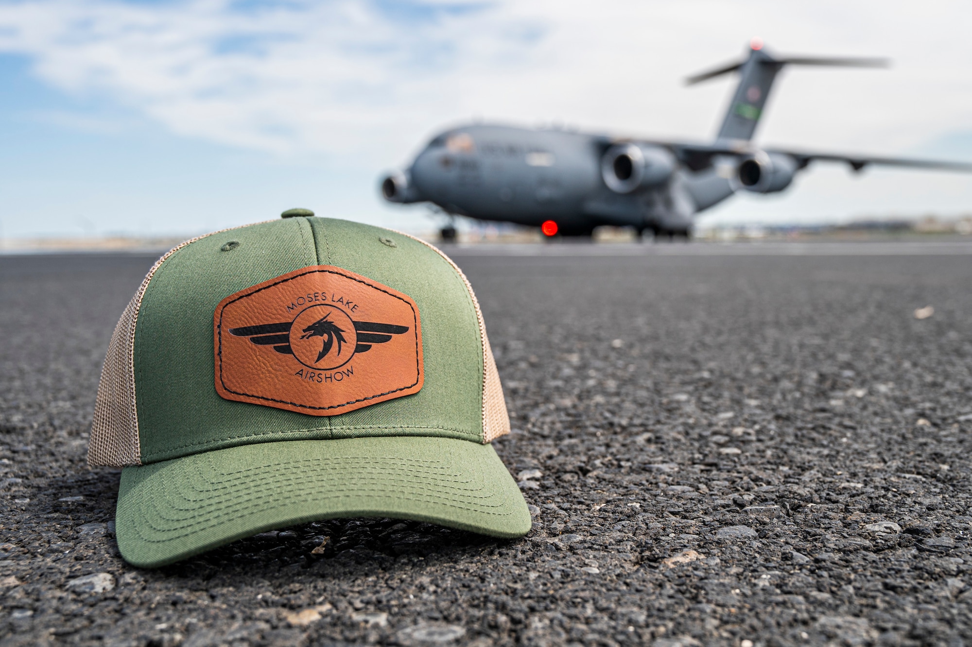 A C-17 Globemaster III and a 2025 Moses Lake Airshow hat sit on the flightline at Grant County International Airport, Washington, June 19, 2025.