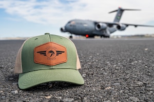 A C-17 Globemaster III and a 2025 Moses Lake Airshow hat sit on the flightline at Grant County International Airport, Washington, June 19, 2025.