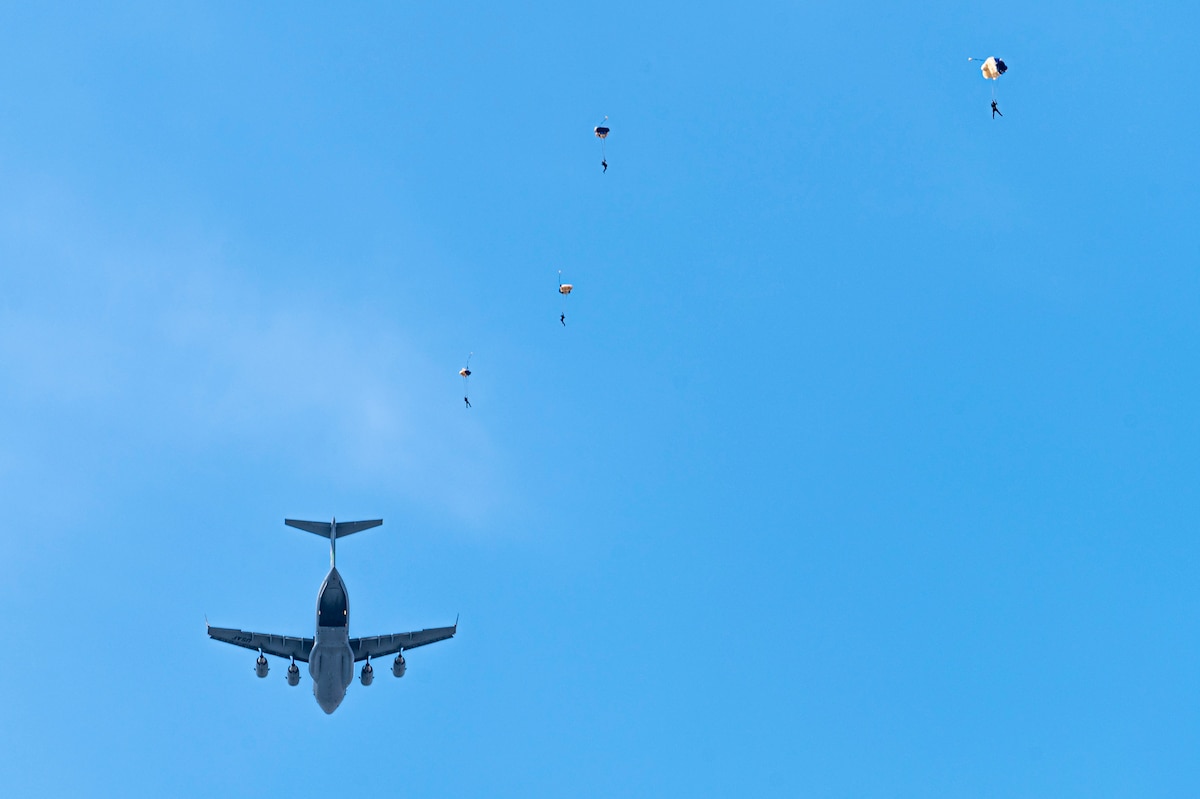 U.S. Air Force Academy Wings of Blue demonstration team members parachute out of a C-17 Globemaster III during the 2025 Moses Lake Airshow at Grant County International Airport, Washington, June 20, 2025.