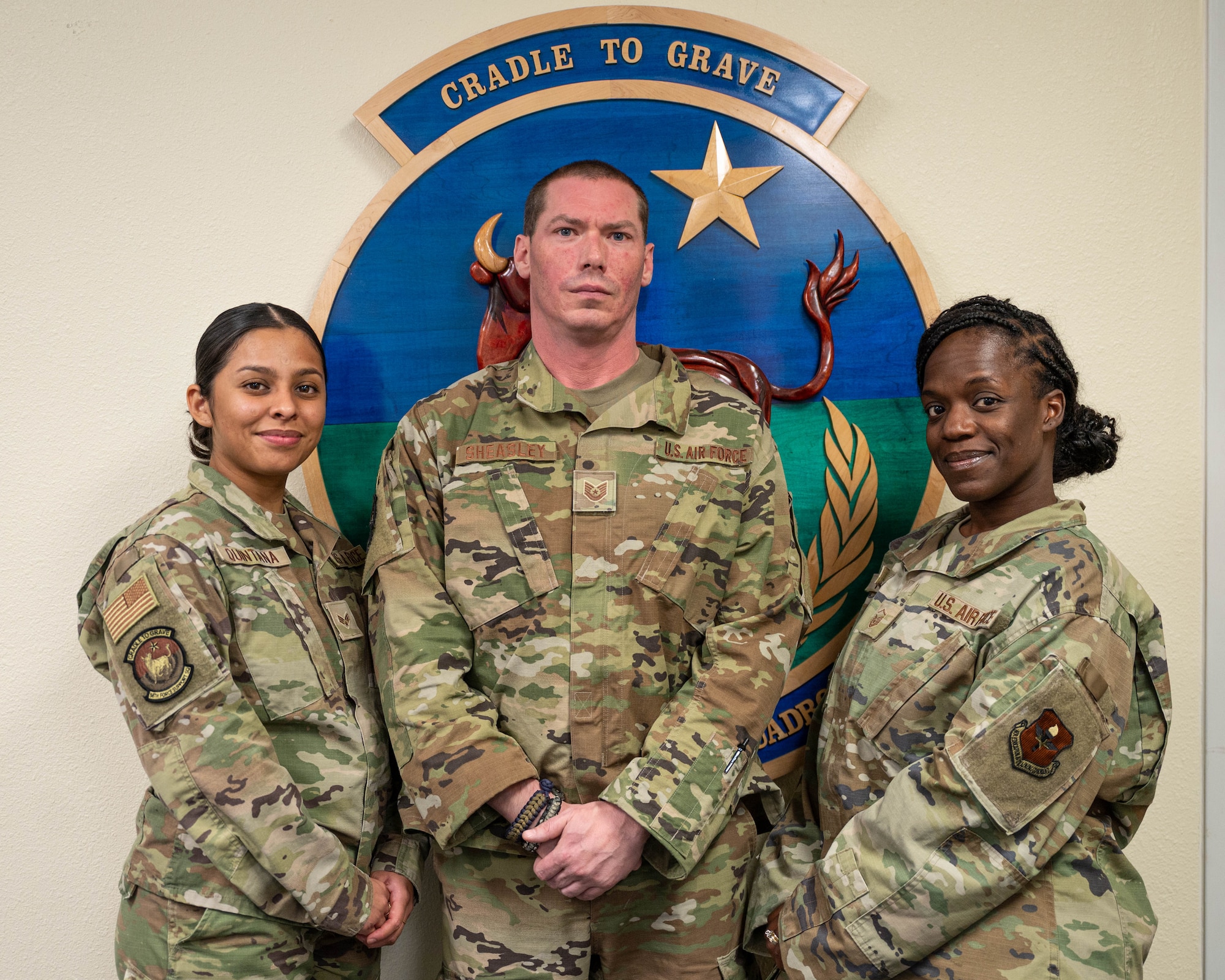 U.S. Air Force Master Sgt. Keyatta Tolbert, 56th Force Support Squadron Readiness and Plans Mortuary Affairs section chief, Tech Sgt. Craig Sheasley (center), 56th Force Support Squadron Readiness and Plans Mortuary Affairs, and U.S. Air Force Senior Airman Aslim Quintana (left), 56th Force Support Squadron Readiness and Plans Mortuary Affairs pose for a photo