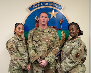 U.S. Air Force Master Sgt. Keyatta Tolbert, 56th Force Support Squadron Readiness and Plans Mortuary Affairs section chief, Tech Sgt. Craig Sheasley (center), 56th Force Support Squadron Readiness and Plans Mortuary Affairs, and U.S. Air Force Senior Airman Aslim Quintana (left), 56th Force Support Squadron Readiness and Plans Mortuary Affairs pose for a photo