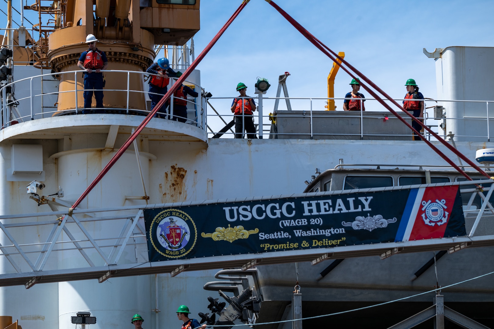 U.S. Coast Guard Cutter Healy (WAGB 20) crewmembers conduct mooring operations to depart from Base Seattle, June 19, 2025. The Healy will conduct high latitude science and research missions in the Arctic. (U.S. Coast Guard photo by Petty Officer 2nd Class Briana Carter)