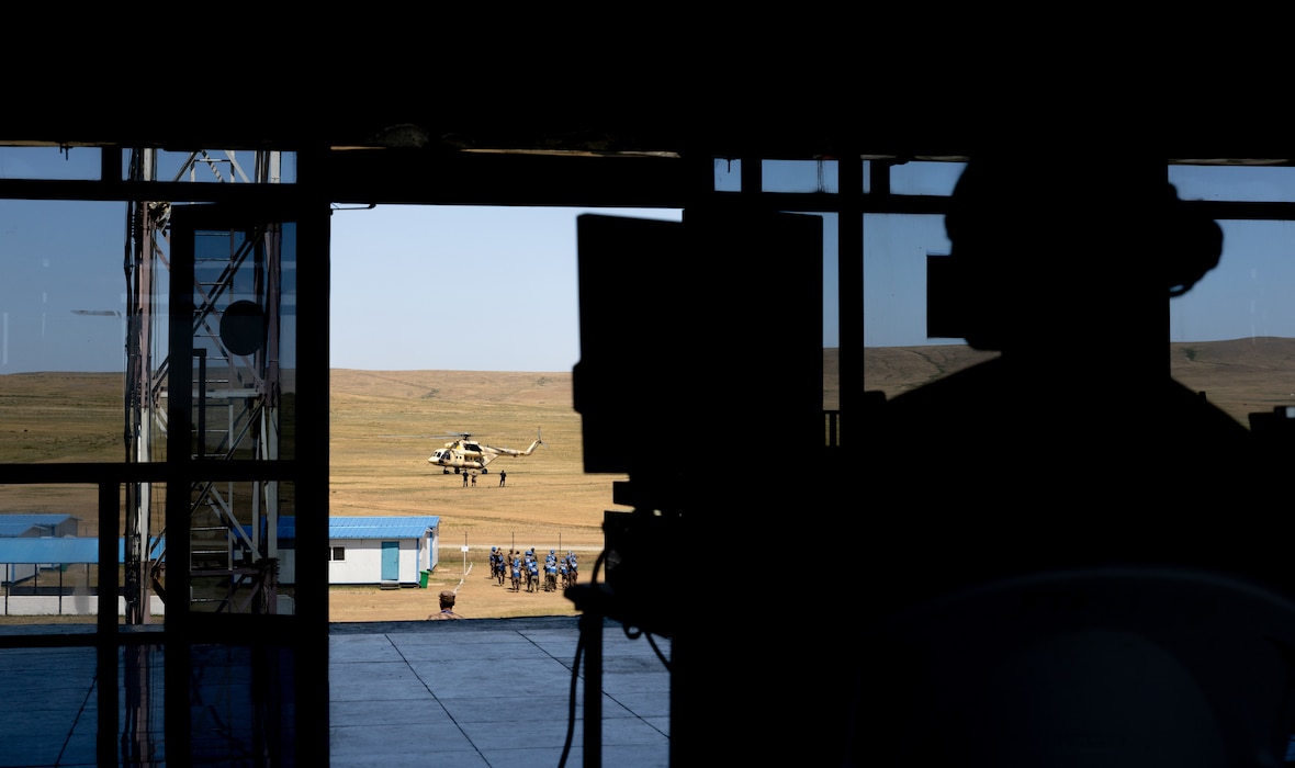U.S. Army Capt. Kali Rose, the company commander of Headquarters and Headquarters company, 125th Finance Battalion, 8th Military Police Brigade, 8th Theater Sustainment Command, conducts admin work in the combined tactical operations center, while U.S. Soldiers, and Mongolian Armed Forces soldiers conduct medical training on June 20, 2025, at Five Hills Training Area, Mongolia.