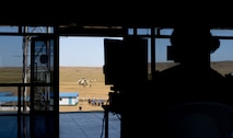 U.S. Army Capt. Kali Rose, the company commander of Headquarters and Headquarters company, 125th Finance Battalion, 8th Military Police Brigade, 8th Theater Sustainment Command, conducts admin work in the combined tactical operations center, while U.S. Soldiers, and Mongolian Armed Forces soldiers conduct medical training on June 20, 2025, at Five Hills Training Area, Mongolia.