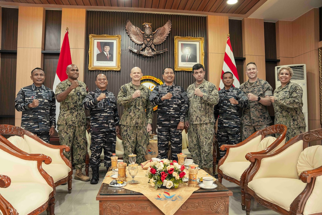 U.S. Navy Capt. Matt Scarlett, commodore, Destroyer Squadron Seven (DESRON 7), fourth from left, poses for a photo with members of the Indonesian Navy, and service members assigned to the DESRON 7 and U.S. Embassy Jakarta, during an office call before the opening ceremony of Cooperation Afloat Readiness and Training (CARAT) Indonesia 2025 at Tentara Nasional Indonesia Angkatan Laut (TNI-AL) headquarters in Surabaya, Indonesia, June 23, 2025.