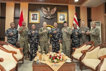 U.S. Navy Capt. Matt Scarlett, commodore, Destroyer Squadron Seven (DESRON 7), fourth from left, poses for a photo with members of the Indonesian Navy, and service members assigned to the DESRON 7 and U.S. Embassy Jakarta, during an office call before the opening ceremony of Cooperation Afloat Readiness and Training (CARAT) Indonesia 2025 at Tentara Nasional Indonesia Angkatan Laut (TNI-AL) headquarters in Surabaya, Indonesia, June 23, 2025.