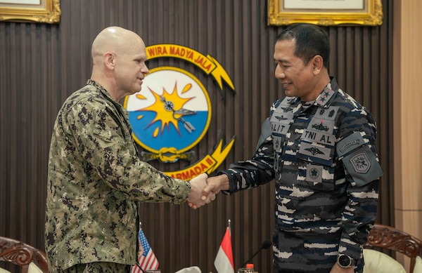 U.S. Navy Capt. Matt Scarlett, commodore, Destroyer Squadron Seven, left, shakes hands with Rear Adm. I Gung Putu Alit Jaya, commander in chief, 2nd Fleet, Indonesian Navy, during an office call before the opening ceremony of Cooperation Afloat Readiness and Training (CARAT) Indonesia 2025 at Tentara Nasional Indonesia Angkatan Laut (TNI-AL) headquarters in Surabaya, Indonesia, June 23, 2025.