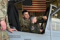 Maryland Air National Guard Tech. Sgt. Daniel Roriguez (left), a crew chief assigned to the 175th Maintenance Squadron, shows Maverick Bell (right) an A-10C Thunderbolt II static display at Warfield Air National Guard Base at Martin State Airport, Maryland, June 7, 2025. Bell and his family attended "Pilot For a Day," facilitated by the Gold in Fight Foundation, which invites children and families from the local community who have catastrophic illnesses to spend the day with pilots. (U.S. Air National Guard Photo by Staff Sgt. Laura Virtue)