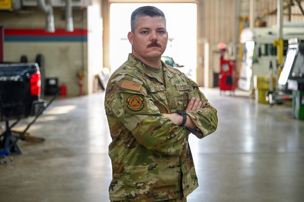 U.S. Air Force Master Sgt. Aaron Bell, 97th Logistics Readiness Squadron vehicle fleet manager, stands in the 97th Maintenance Squadron vehicle bay at Altus Air Force Base, Oklahoma, May 20, 2025. Bell was selected to compete for the top 9 Outstanding Airmen of the Year in Washington, D.C. (U.S. Air Force photo by Airman 1st Class Nathan Langston)