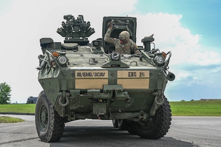 army soldiers parking Stryker combat vehicles