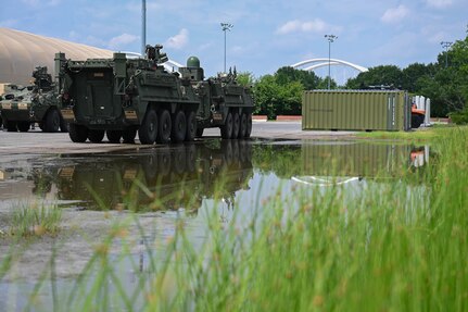 army soldiers parking Stryker combat vehicles