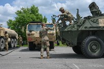 army soldiers parking Stryker combat vehicles