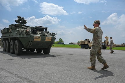 army soldiers parking Stryker combat vehicles