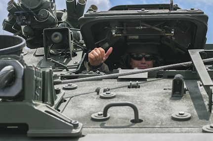 army soldiers parking Stryker combat vehicles