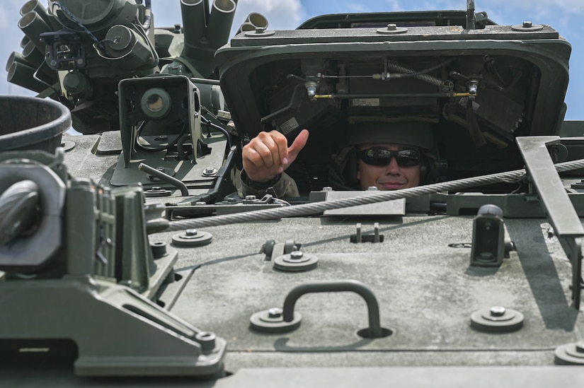 army soldiers parking Stryker combat vehicles