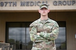 U.S. Air Force Staff. Sgt. Jack Brown, 97th Healthcare Operations Squadron TRICARE operations and patient administration non-commissioned officer in charge, stands in front of the 97th Medical Group Building at Altus Air Force Base, Oklahoma, May 28,2025. Brown was recently promoted to the rank of staff sergeant within five years of service. (U.S. Air Force photo by Airman 1st Class Nathan Langston)