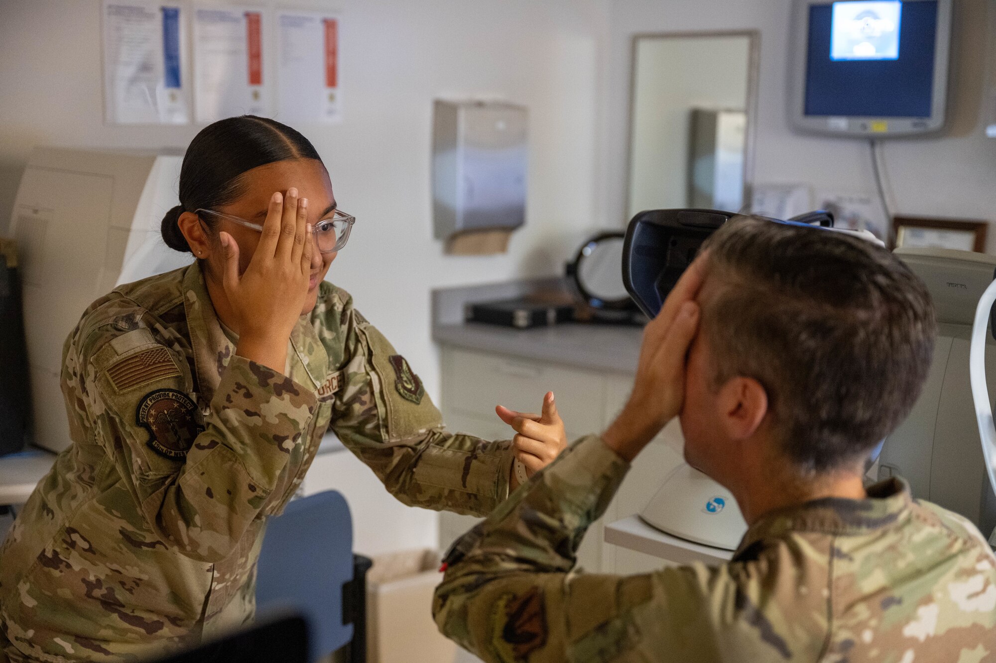 A U.S. Air Force Airmen conducts an eye test on a patient in an optometry office on Joint Base Pearl Harbor-Hickam, Hawaii.