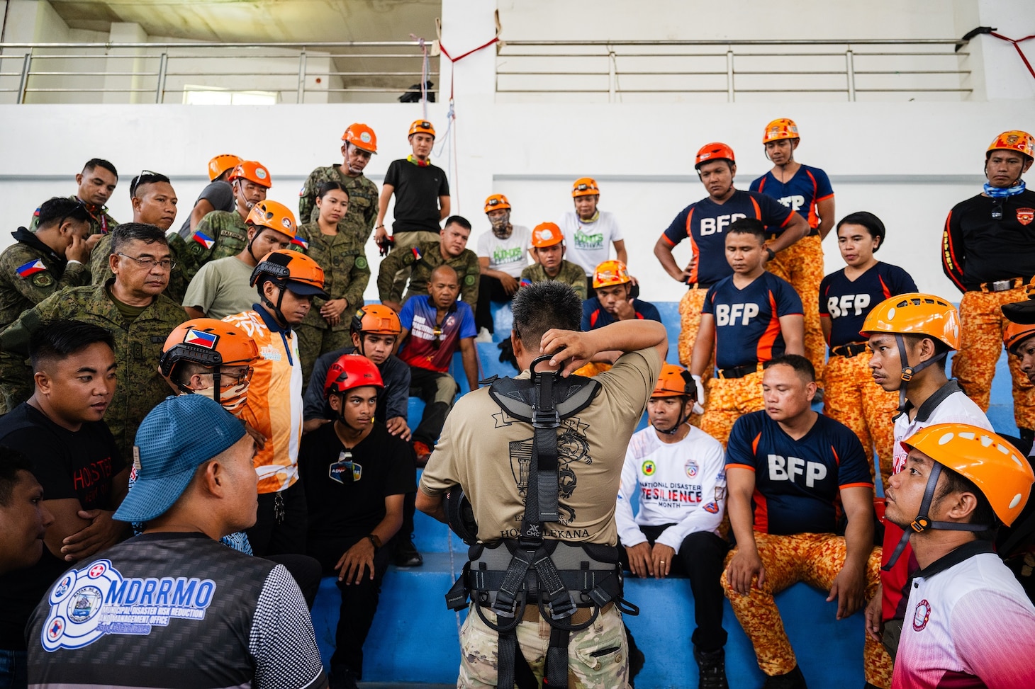 Virac, Philippines (June 3, 2025) – Hawaii National Guard 1st Sgt. Rodolfo Acosta, center, instructs local emergency responders and civilian authorities on the proper use of rappelling gear during a training session in Virac, Philippines, June 3, 2025. This effort is part of a two-week urban rescue training exercise supporting the humanitarian assistance and disaster response objectives of Pacific Partnership 2025. Now in its 21st iteration, Pacific Partnership series is the largest annual multinational humanitarian assistance and disaster management preparedness mission conducted in the Indo-Pacific. Pacific Partnership works collaboratively with host and partner nations to enhance regional interoperability and disaster response capabilities, increase security and stability in the region, and foster new and enduring friendships in the Indo-Pacific. (U.S. Navy photo by Mass Communication Specialist 2nd Class Jordan Jennings)