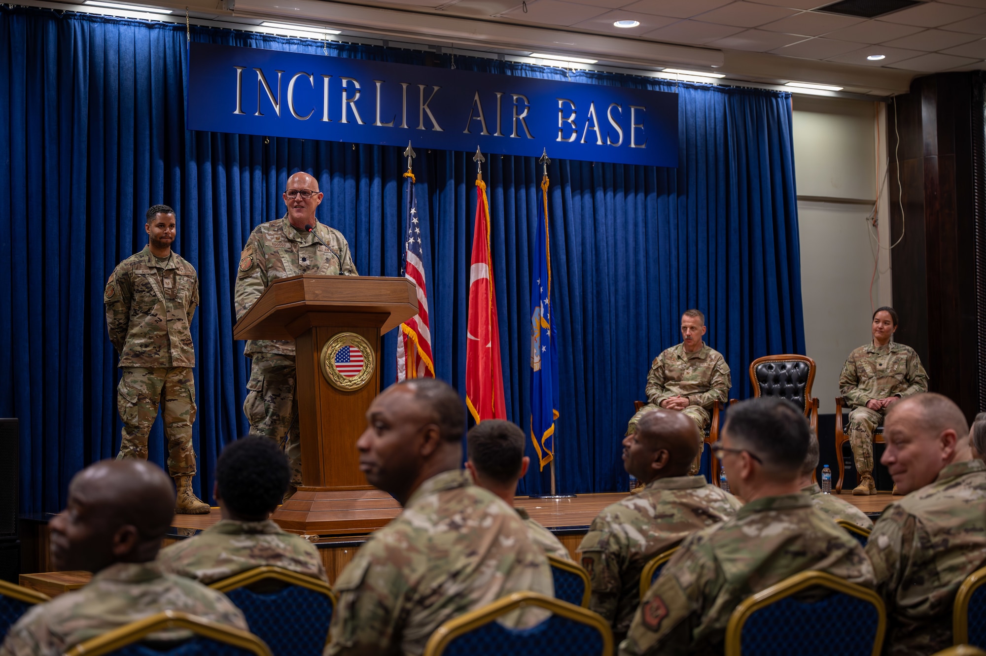 U.S. Air Force Lt. Col. Richard Odosso, 39th Operational Medical Readiness Squadron outgoing commander, delivers remarks during a change of command ceremony at Incirlik Air Base, Turkey, June 10, 2025. The change of command ceremony is a long-standing military tradition that represents the formal transfer of responsibility from one officer to another. (U.S. Air Force photo by Staff Sgt. Koby I. Saunders)