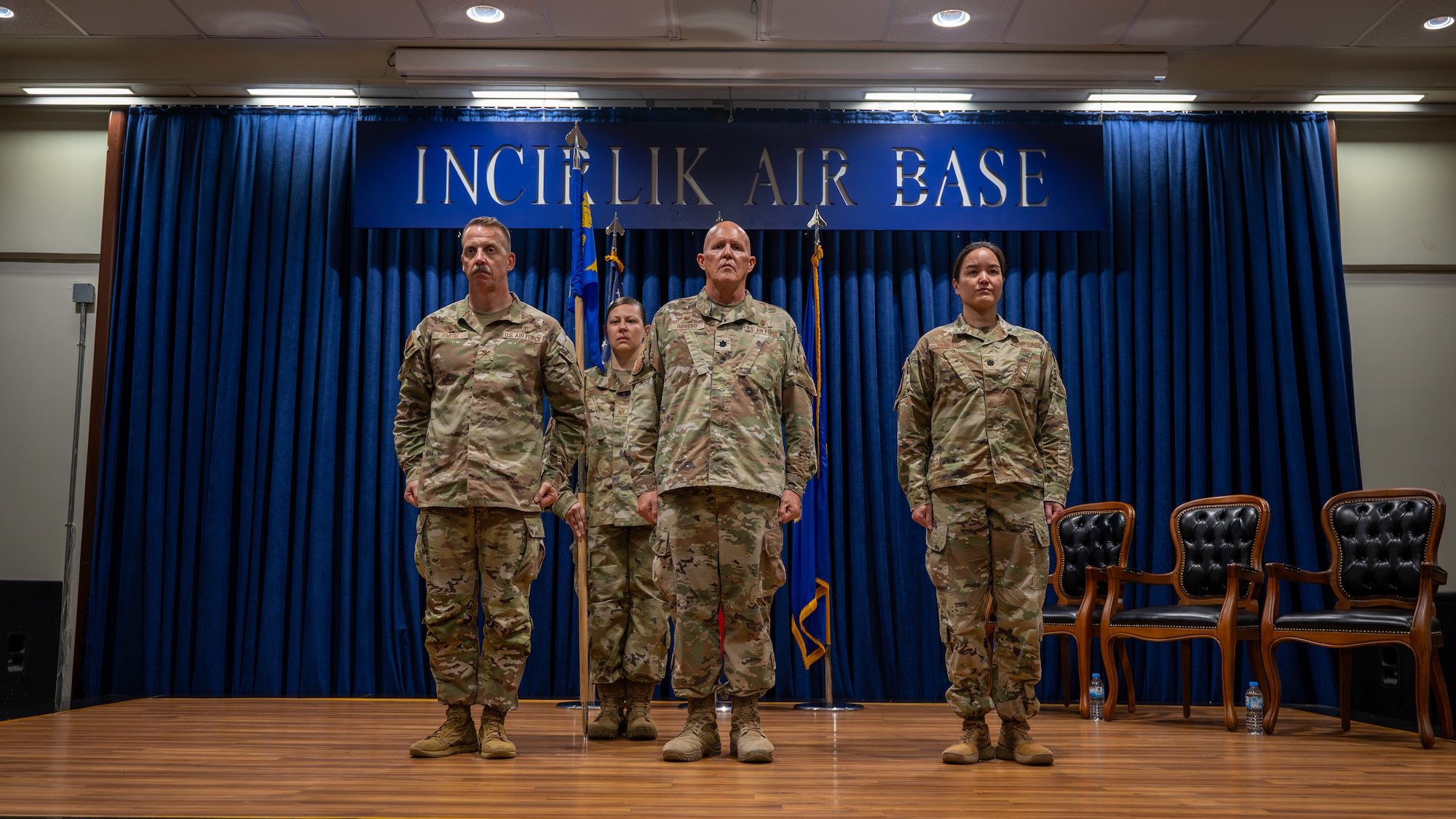 U.S. Air Force Col. Christian Smith, left, 39th Medical Group commander, Lt. Col. Richard Odosso, 39th Operational Medical Readiness Squadron outgoing commander, Lt. Col. Michelle Reneau, 39th Operational Medical Readiness Squadron incoming commander, right, stand at attention during a change of command ceremony at Incirlik Air Base, Turkey, June 10, 2025. The change of command ceremony is a long-standing military tradition that represents the formal transfer of responsibility from one officer to another. (U.S. Air Force photo by Staff Sgt. Koby I. Saunders)